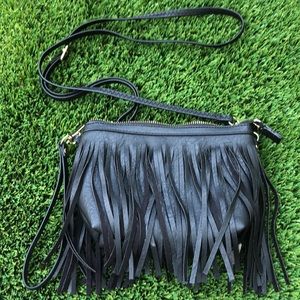 Black and gold purse with hanging strings,